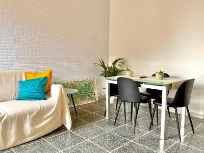 a living room with a couch and a table and chairs at La Dolce Vita - Roman Experience in Rome
