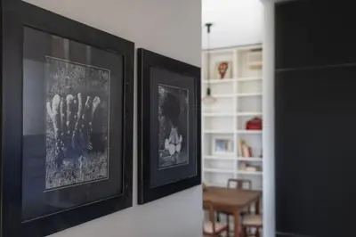 two framed pictures on a wall in a living room at Urban Haven Roma, Porta Maggiore in Rome