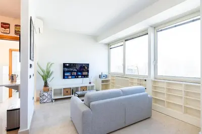a living room with a couch and a tv at Urban Haven Roma, Porta Maggiore in Rome