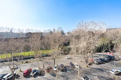 a parking lot with a bunch of cars parked at Urban Haven Roma, Porta Maggiore in Rome