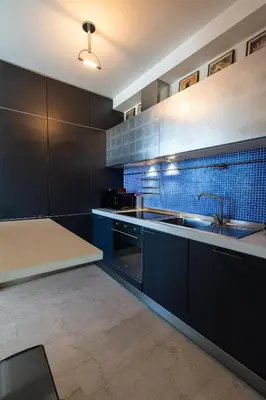 a kitchen with black cabinets and a sink at Urban Haven Roma, Porta Maggiore in Rome