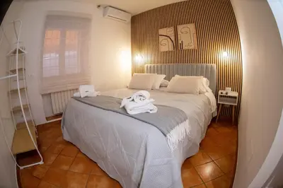 a bedroom with a bed with two towels on it at Welcoming Vatican Garden Home - with Hot Hub in Rome