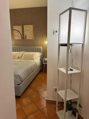 a bedroom with a bed and a shelf in a room at Welcoming Vatican Garden Home - with Hot Hub in Rome