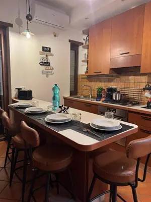a kitchen with a large island in the middle at Welcoming Vatican Garden Home - with Hot Hub in Rome