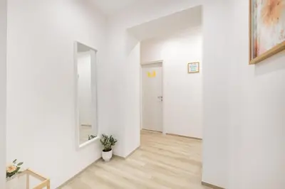 an empty hallway with white walls and a mirror at central basic apartment in Rome