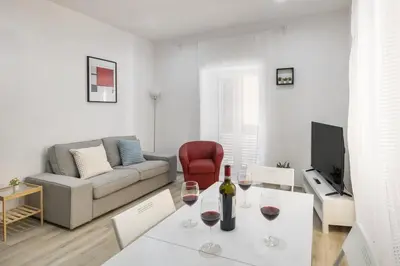 a living room with a couch and a table with wine glasses at central basic apartment in Rome