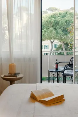 a bedroom with a bed and a view of a balcony at The Romex in Rome