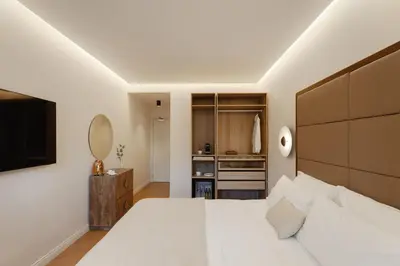 a bedroom with a large white bed and a television at The Romex in Rome