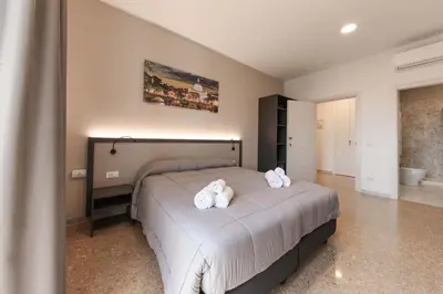 a bedroom with a bed with two towels on it at auntieshouseroma in Rome