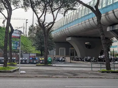 a building with motorcycles parked in a parking lot at auntieshouseroma in Rome