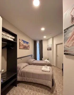 a bedroom with two beds and a tv in it at auntieshouseroma in Rome