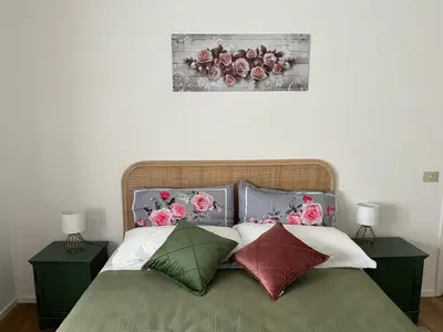 a bedroom with a bed with flowers on the wall at The Rose Apt in Rome