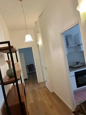 a small room with a kitchen and a room with a ladder at The Rose Apt in Rome