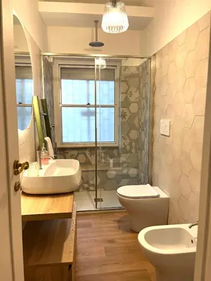 a bathroom with a sink and a toilet and a shower at The Rose Apt in Rome