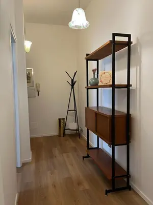 a room with a book shelf and a lamp at The Rose Apt in Rome