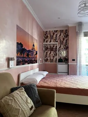 a bedroom with two beds and a couch at ALCAVE holiday home in Rome