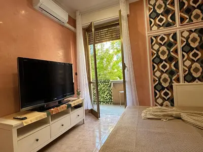 a living room with a flat screen tv on a wall at ALCAVE holiday home in Rome