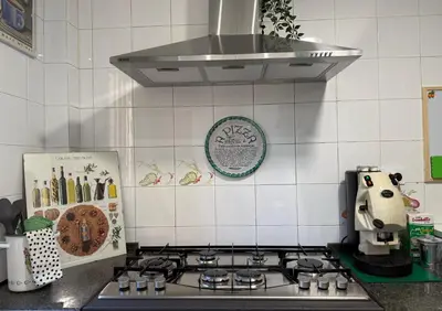a kitchen with a stove with a coffee maker on it at ALCAVE holiday home in Rome