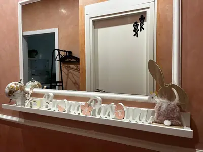 a shelf in front of a mirror in a room at ALCAVE holiday home in Rome