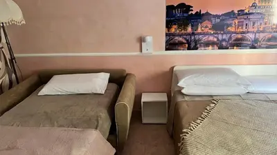 a small room with a bed and a small bed sidx sidx sidx at ALCAVE holiday home in Rome