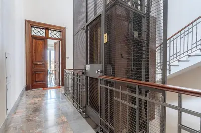 a hallway with a large wall of bird cages at La Galleria, Rooftop Flat Nearby Villa Borghese in Rome