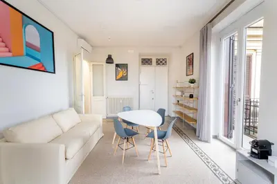 a living room with a white couch and a table at La Galleria, Rooftop Flat Nearby Villa Borghese in Rome