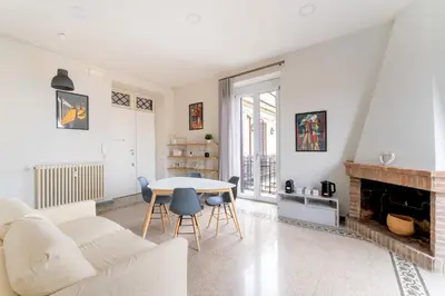 a living room with a white couch and a table at La Galleria, Rooftop Flat Nearby Villa Borghese in Rome