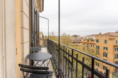 a table and two chairs on a balcony with a view at La Galleria, Rooftop Flat Nearby Villa Borghese in Rome