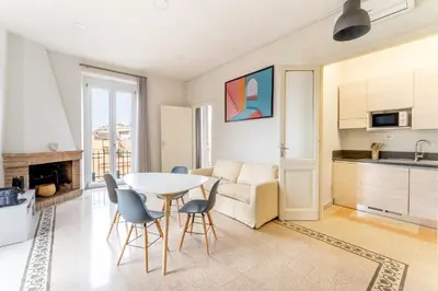 a kitchen and living room with a table and chairs at La Galleria, Rooftop Flat Nearby Villa Borghese in Rome
