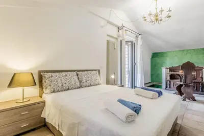 a bedroom with a large white bed with two pillows at Ninkasi Bed and Beer Loft in Rome