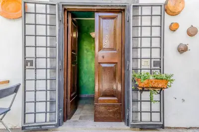 an entrance to a house with a wooden door at Ninkasi Bed and Beer Loft in Rome