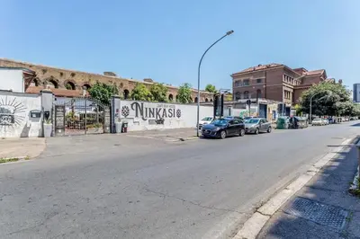 an empty street with cars parked on the side of a building at Ninkasi Bed and Beer Loft in Rome