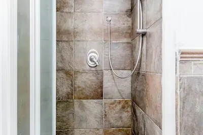 a shower with a hose in a bathroom at Ninkasi Bed and Beer Loft in Rome