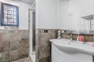 a bathroom with a white sink and a shower at Ninkasi Bed and Beer Loft in Rome