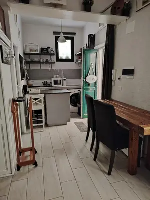 a kitchen and dining room with a table and chairs at Casetta indipendente Testaccio Roma Centro in Rome