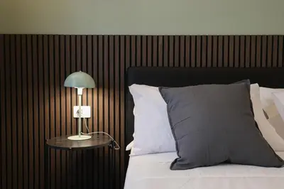 a bed with a lamp on a table next to it at LRV Apartment Roma Metro B Conca d'Oro in Rome