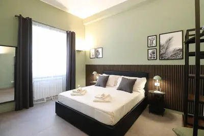 a bedroom with a large bed and a large window at LRV Apartment Roma Metro B Conca d'Oro in Rome