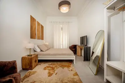a living room with a bed and a tv at Roma Borghese - casa vacanze in Rome