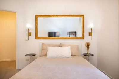 a bedroom with a bed with a mirror on the wall at Roma Borghese - casa vacanze in Rome