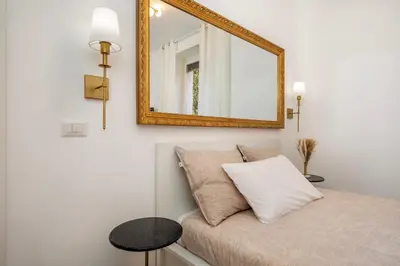 a mirror on the wall above a bed in a room at Roma Borghese - casa vacanze in Rome