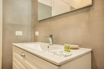 a bathroom with a sink and a mirror at Roma Borghese - casa vacanze in Rome