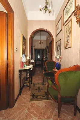 a hallway with chairs and a table in a room at Casa Bianca room 16 in Rome