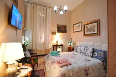 a bedroom with a bed with pink towels on it at Casa Bianca room 16 in Rome