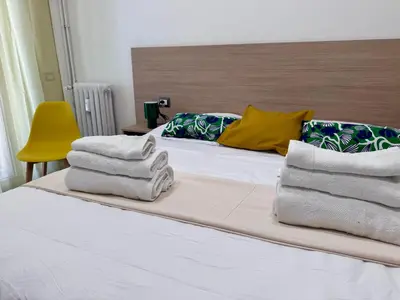 a bedroom with a bed with towels on it at Costabella Guest House in Rome