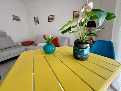 a yellow table with a plant on top of it at Costabella Guest House in Rome