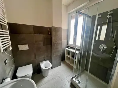 a bathroom with a toilet and a sink and a shower at Costabella Guest House in Rome