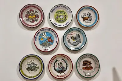 a group of plates on a white wall at Costabella Guest House in Rome