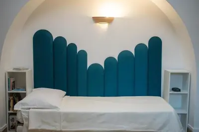 a bedroom with a bed with a blue wall at Statilia 1 Apartment in Rome