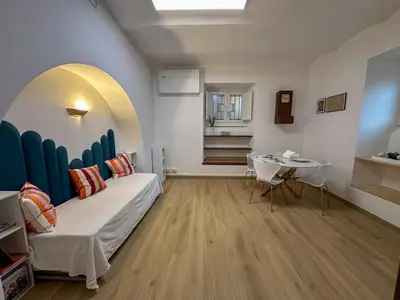 a living room with a bed and a table at Statilia 1 Apartment in Rome