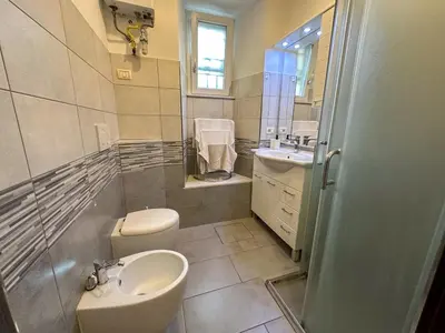 a bathroom with a toilet and a sink at Statilia 1 Apartment in Rome